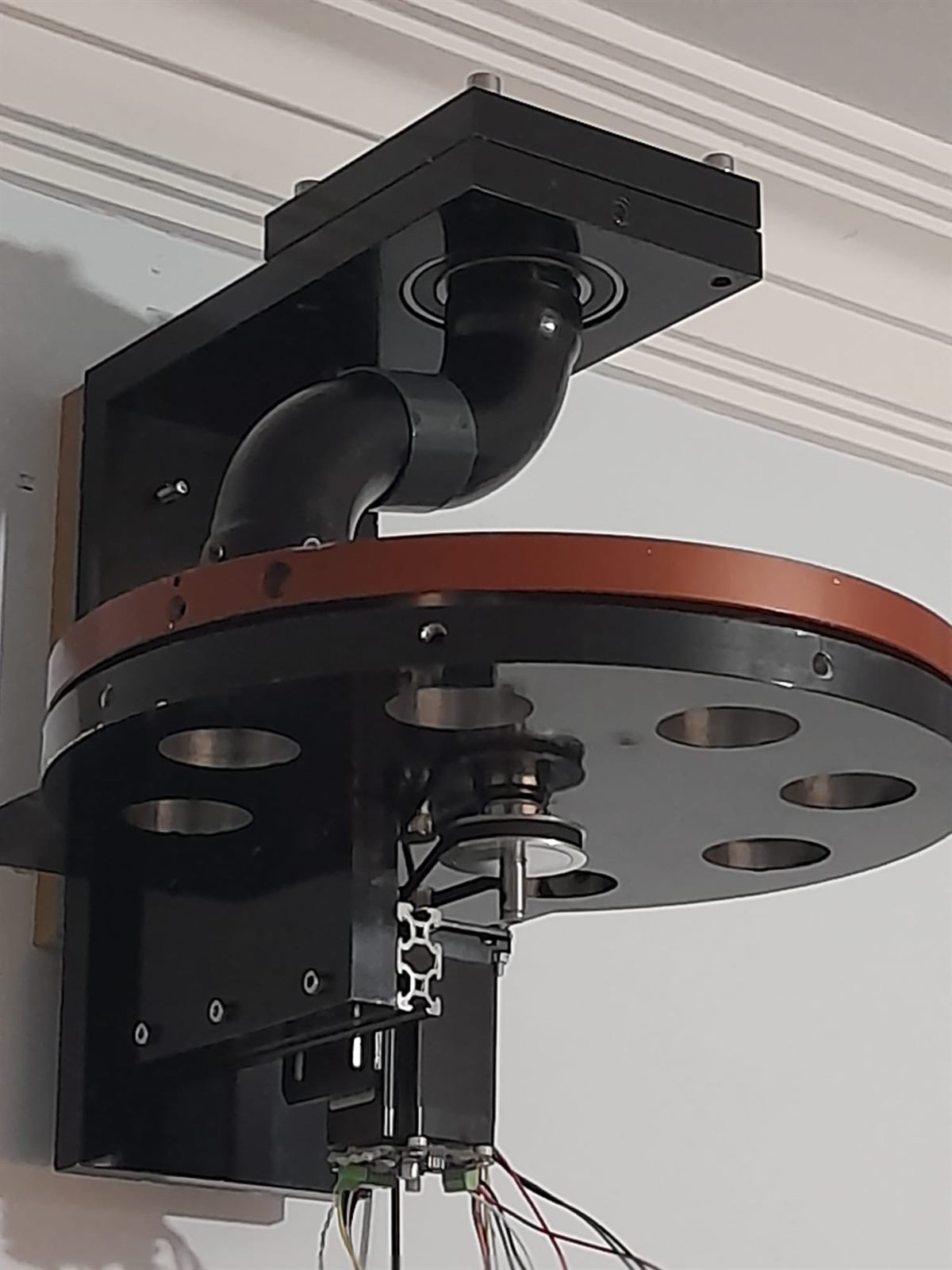 Rotary distributor unit seen from below showing its outlet ports