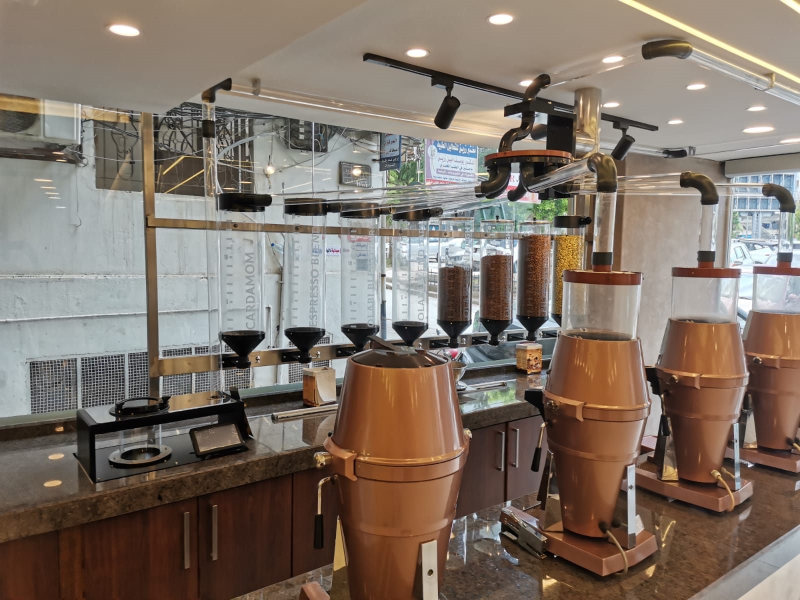 Row of transparent display silos labelled with coffee blends