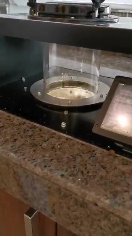 Roasted beans swirling inside the glass vacuum chamber of the loading station